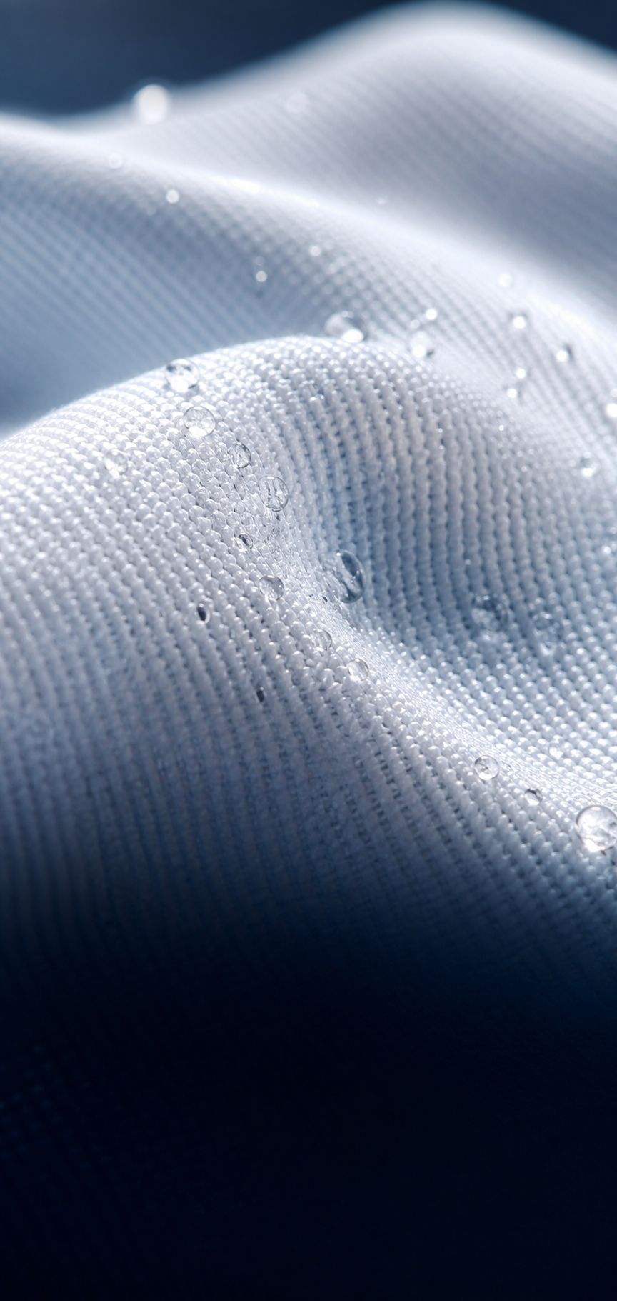 Macro view of breathable white performance fabric with moisture droplets