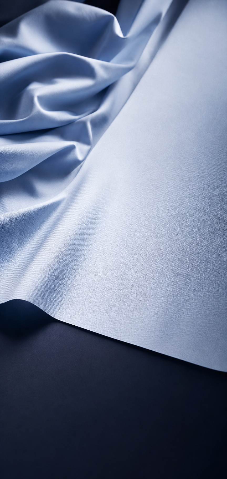 Pale blue performance fabric transitioning from soft folds to a smooth surface